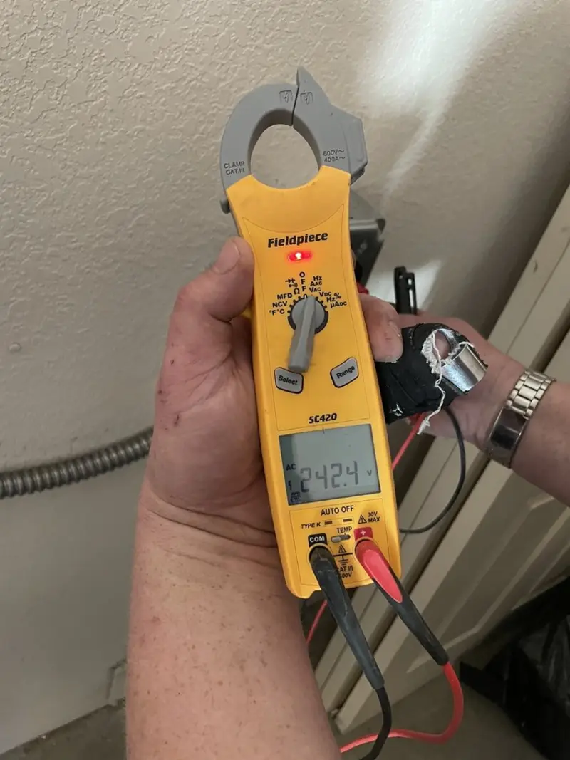 Voltage testing with clamp meter during Electrical Installation Services in Kendall West